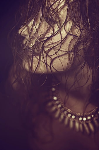Close-up of woman with messy hair and jewelry