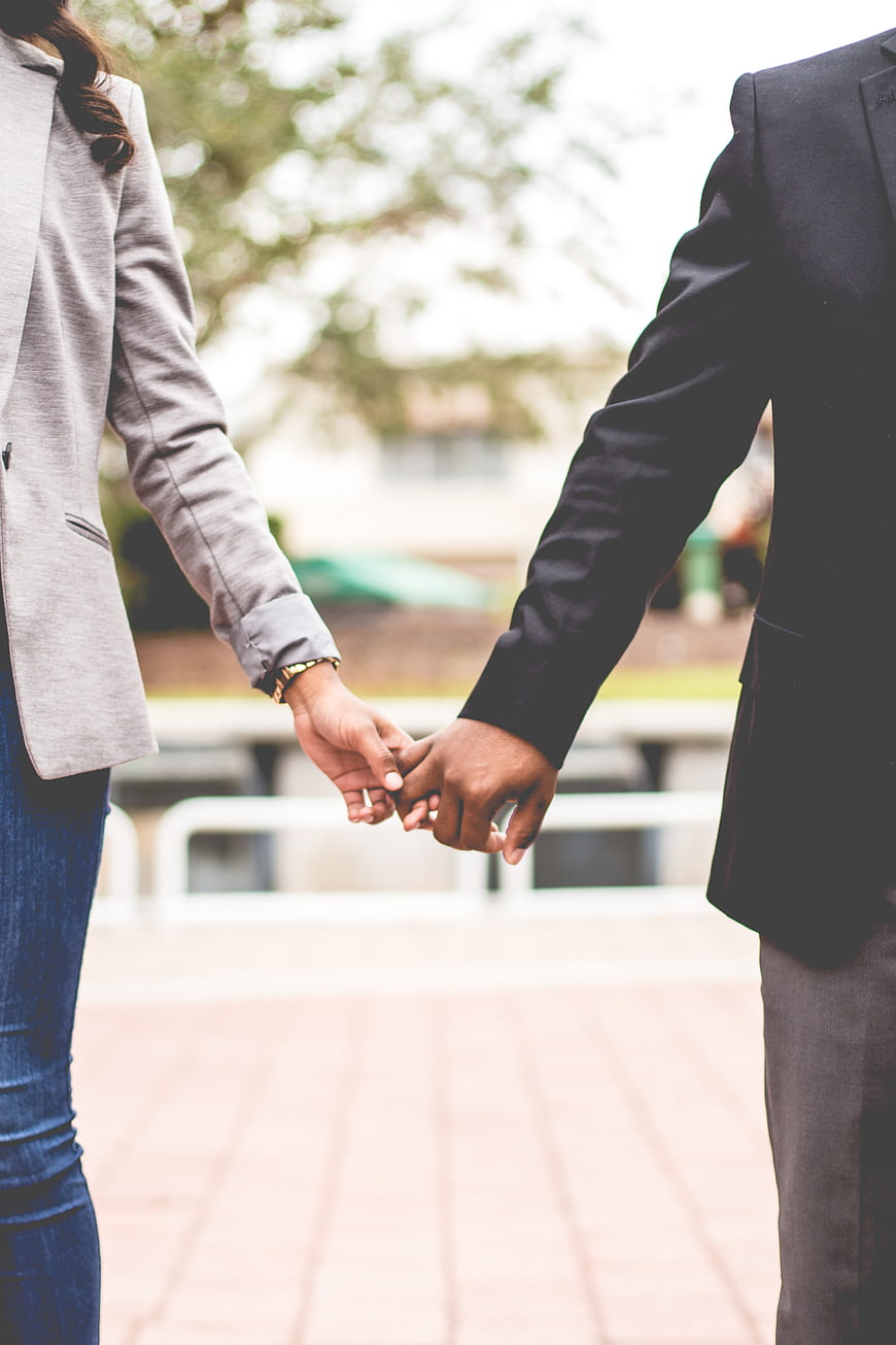 Business Couple Holding Hands Outdoors