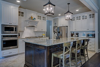 Modern kitchen with white cabinets and dark island