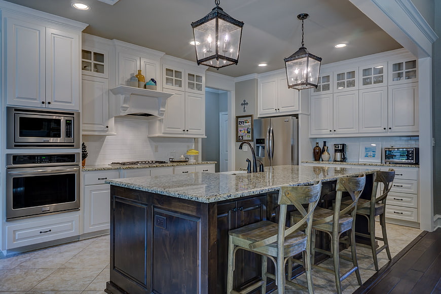 Modern kitchen with white cabinets and dark island