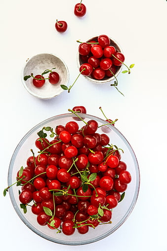 Fresh Red Cherries in Glass and Ceramic Bowls Top View