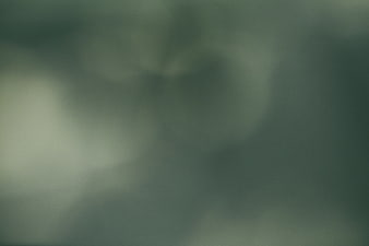 Abstract dark green bokeh background with soft glowing lights