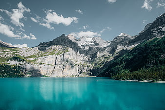 Alpine Lake With Turquoise Water And Snow-Capped Mountain Peaks