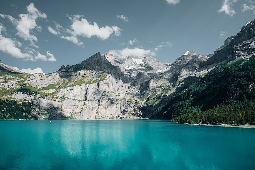 Alpine Lake With Turquoise Water And Snow-Capped Mountain Peaks