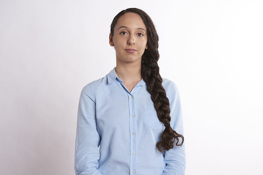 Portrait of Young Woman with Braid in Blue Shirt