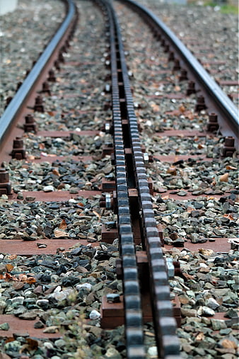Close-up of railway tracks with gravel ballast and wooden sleepers