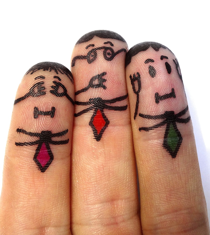 Three fingers painted with see no evil monkey faces