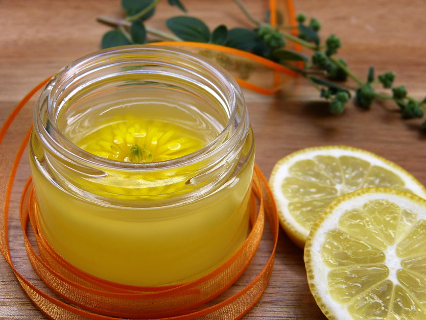 Natural herbal oil with calendula flower and lemon slices