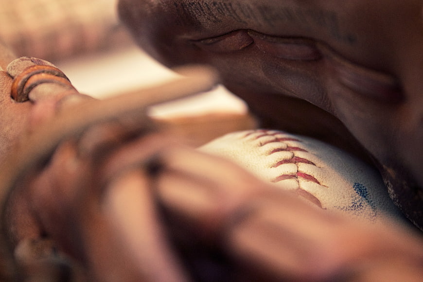 Close-up of baseball glove holding a baseball