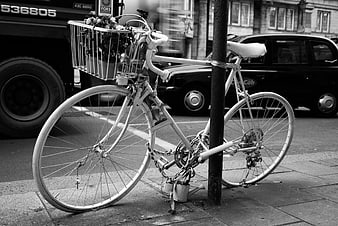 White bicycle with flowers locked to a post in London