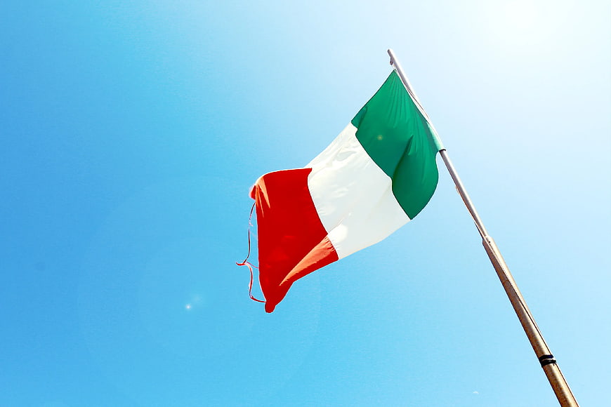 Italian flag waving against clear blue sky