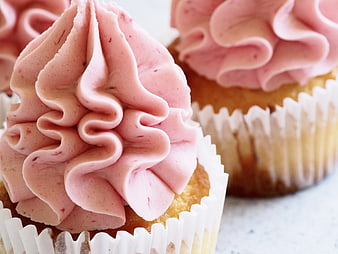 Close-up of pink frosted cupcakes with swirl icing