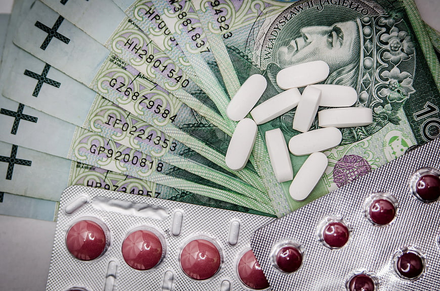 White Pills and Blister Pack on Polish Zloty Banknotes