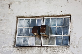 Rusty metal ventilation hoods on old window