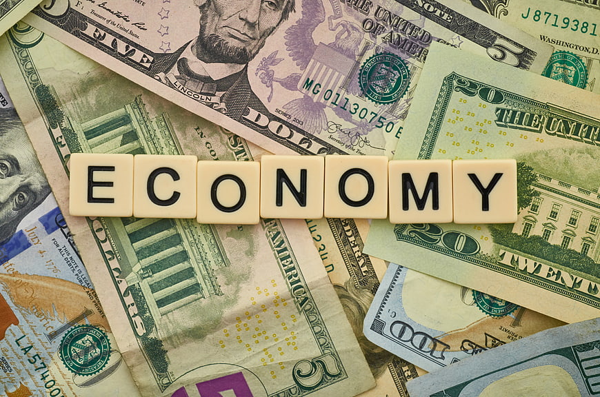 Economy spelled with letter tiles on US dollar bills