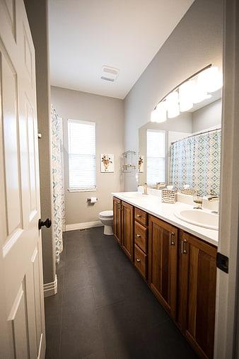 Modern Bathroom Interior with Double Vanity and Dark Floors