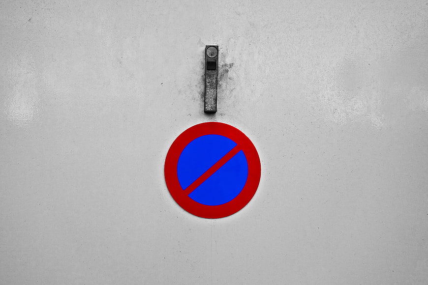 No Parking Sign on Gray Garage Door with Handle