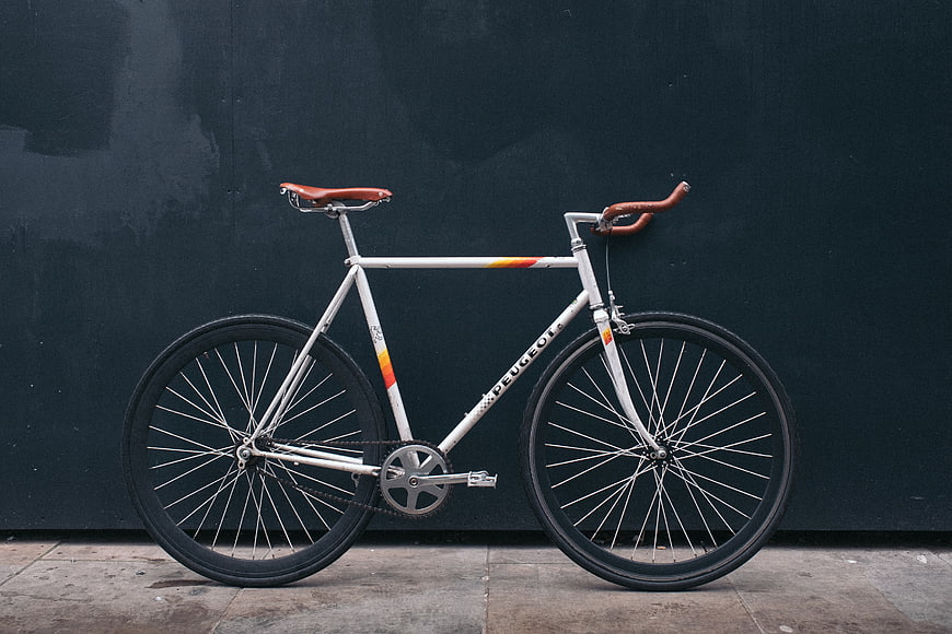 Vintage Peugeot Bicycle Against Dark Wall
