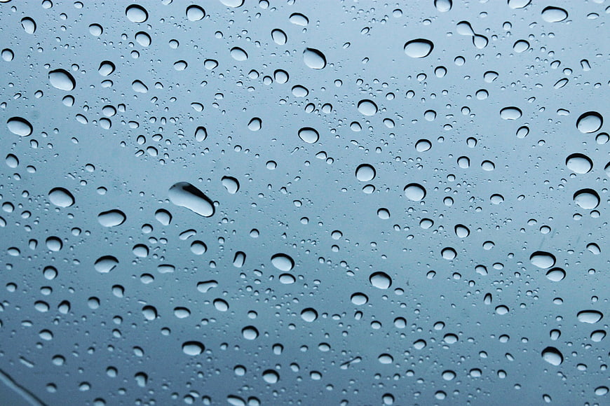 Raindrops on Glass Window Background