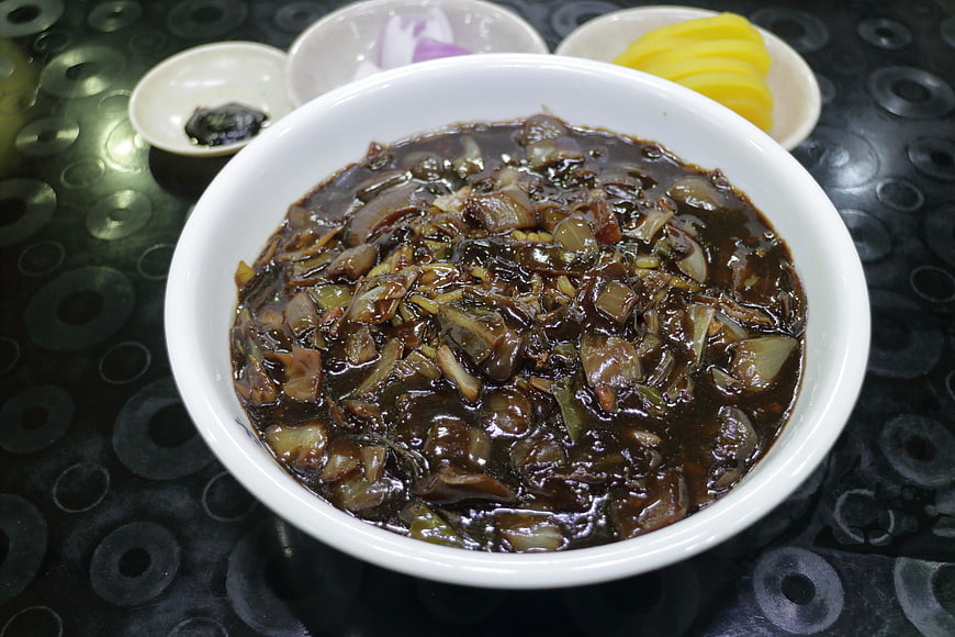 Bowl of Korean Jajangmyeon Sauce with Pickled Radish