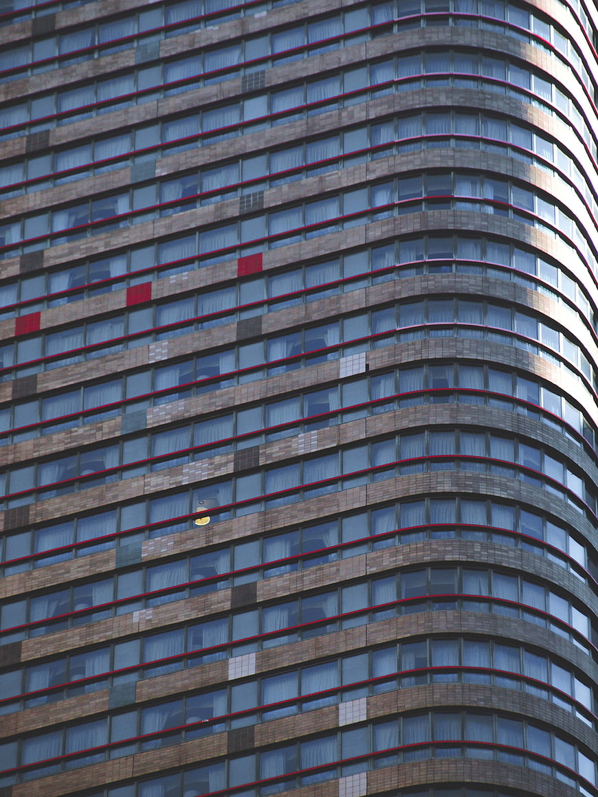 Curved Modern Skyscraper Facade with Red Accents