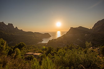 Golden Sunset Over Coastal Mountain Valley with Sea Reflection