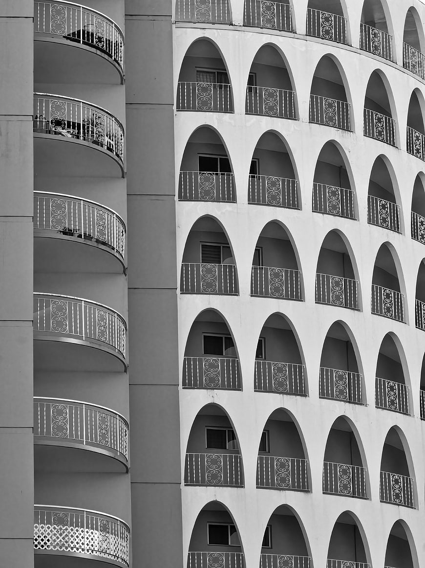 Black and white architectural pattern of curved balconies
