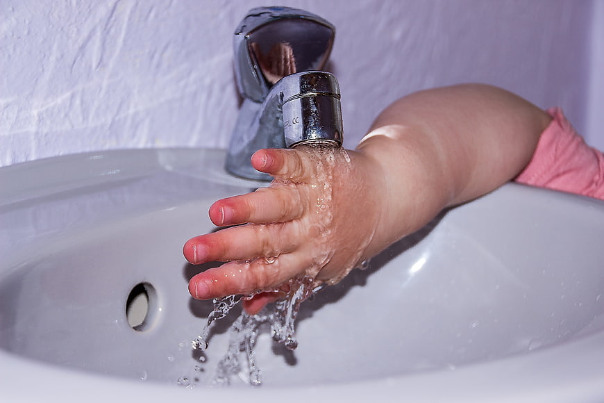 Toddler Washing Hands Under Running Tap Water