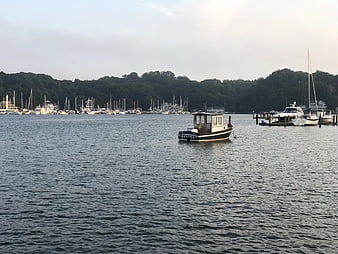 Small boat named Martha anchored in calm marina waters