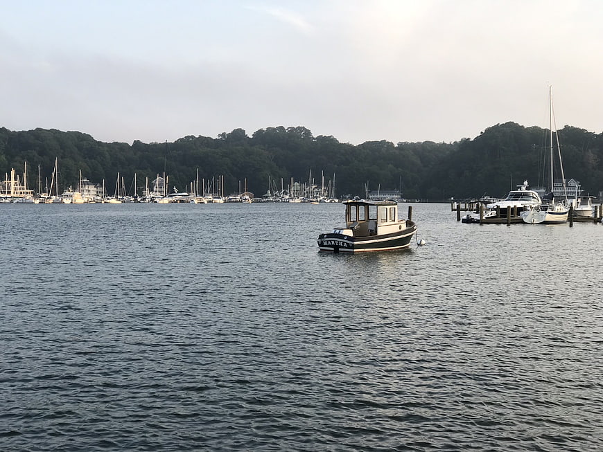 Small boat named Martha anchored in calm marina waters