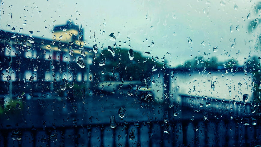 Raindrops on Window Glass with Blurred City View