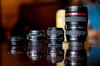 Collection of Canon Camera Lenses on Reflective Surface