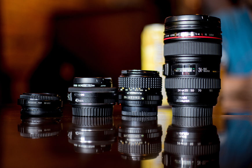 Collection of Canon Camera Lenses on Reflective Surface
