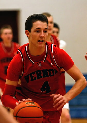 High School Basketball Player Dribbling in Red Jersey