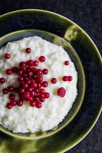 Creamy Rice Pudding with Red Currants in Green Bowl