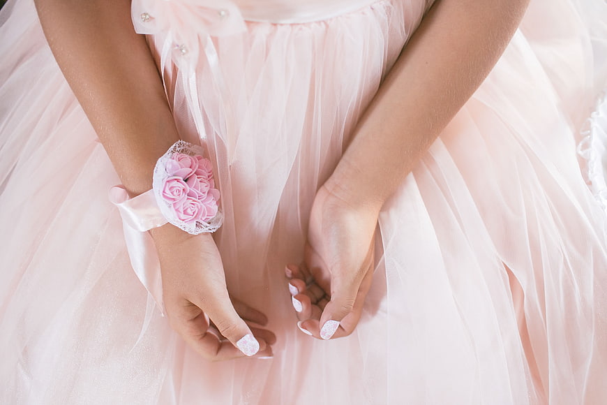 Close-up of girl in pink dress with floral wrist corsage