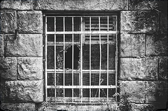 Barred Window In Weathered Stone Wall Black And White