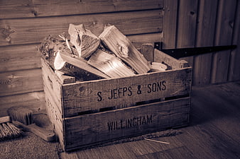 Rustic wooden crate filled with chopped firewood logs