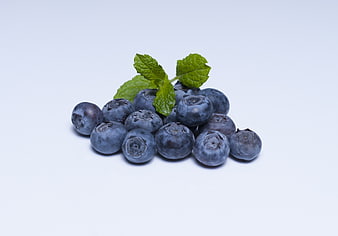 Fresh Blueberries With Mint Leaves On White Background