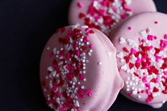 Pink Chocolate Cookies with Heart Sprinkles on Black Background