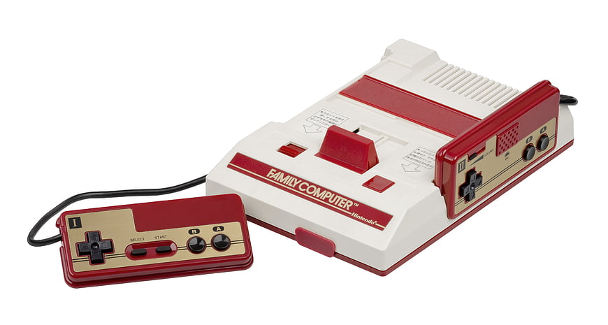 Nintendo Family Computer Console And Controller On White Background