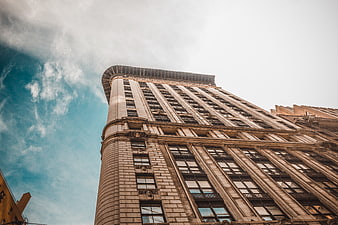 Low angle view of historic skyscraper against blue sky