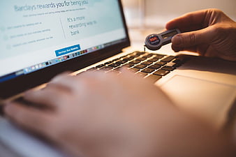 Hand holding RSA security token for online banking