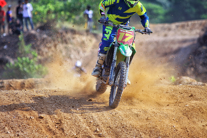 Motocross Rider Racing on Dirt Track