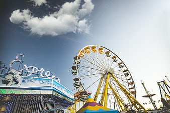 Ferris Wheel and Amusement Park Ride Against Blue Sky