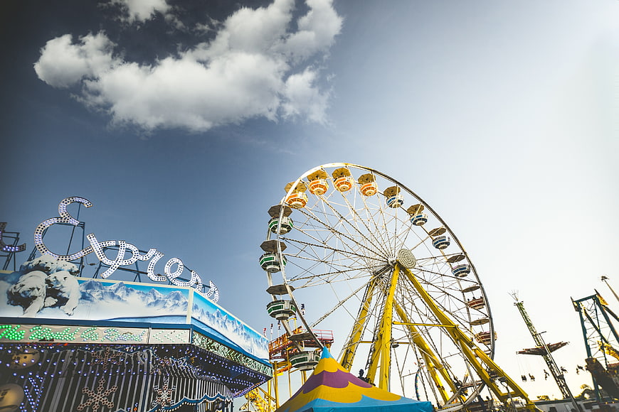 Ferris Wheel and Amusement Park Ride Against Blue Sky