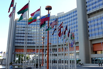 International flags flying in front of the United Nations Vienna headquarters