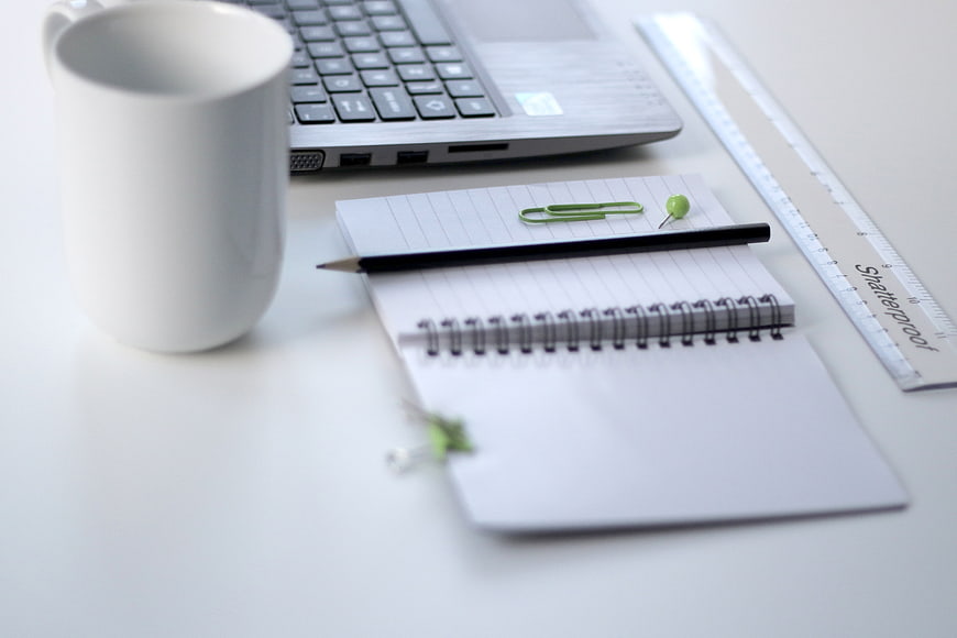 Minimalist Workspace with Laptop, Notebook, and Coffee Mug