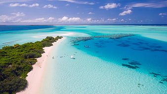 Aerial view of tropical island with turquoise water and white sand beach