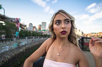 Stylish Blonde Woman Portrait with City Skyline Background